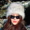 Furry hat in russian style. Gray white fluffy hat. Cute fuzzy winter hat. Slavic girl.