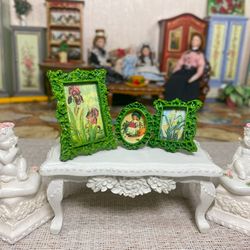 A set of frames with images of flowers. Dollhouse miniature. 1:12.