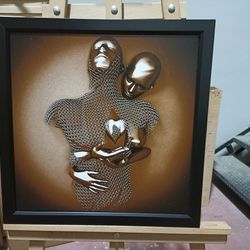 embrace of unity,intertwined figures, golden embrace, unity art, modern sculpture, mesh patterns, emotional connection,