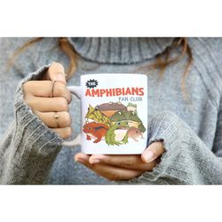 the amphibians fan club frog coffee mug, frog artsy meme mug, aesthetic frog mug novelty, weird retro frog and toad gift