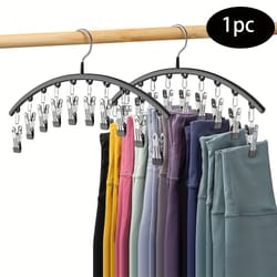 space-saving closet organizer with clips hangs pairs of leggings, efficient black hanger