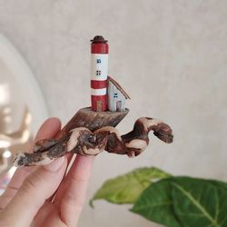 A miniature. Lighthouse and house in the raging sea in a nautical style, made of driftwood, home decor and a great gift.