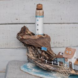 A large island. Driftwood. A seaside town, a lighthouse and fishermen's houses. A gift and decor in a nautical style
