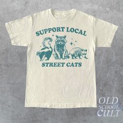 support your local street cats graphic t-shirt, retro unisex adult t shirt, vintage raccoon t shirt, nostalgia t shirt,