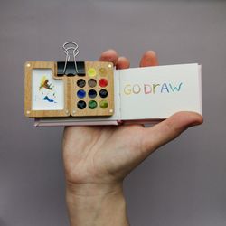 Mini wooden watercolor palette, with tiny sketchbook.