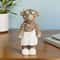 Whimsical Home Desktop Decoration, Highland Cow Wearing a Bathrobe with Eyes Sticking to a Cucumber Statue