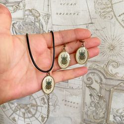 A set of jewelry with the image of beetles. Individual design.