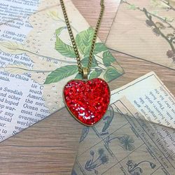 Pendant on a cord. Red heart. Handmade jewelry.3D effect.