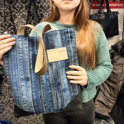 Stylish denim shopper made of denim belts with pockets inside- decorated with leather