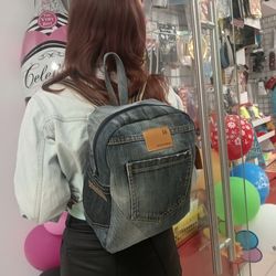unisex denim backpack made from eco-friendly recycled jeans, with 2 pockets outside and 3 pockets inside