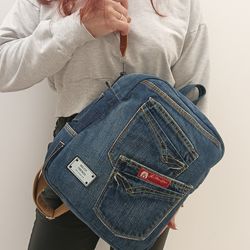 stylish and comfortable denim blue casual backpack handmade from recycled jeans, with 8 pockets pockets, cotton lining,