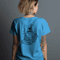 back-view-of-a-white-female-model-posing-in-white-tshirt-in-front-of-grey-screen-looking-left-00188.png