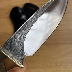 premium hunting knife with wolf engraved blade, ebony handle & brass bolsters