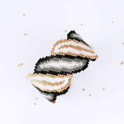beading pattern for delica bracelet with shiny gold, white and black spiral scroll. bold design for advanced beaders!