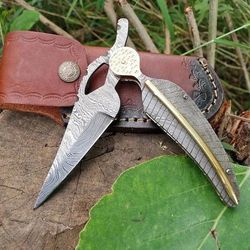 handmade damascus steel folding knife with feather look and bronze accents