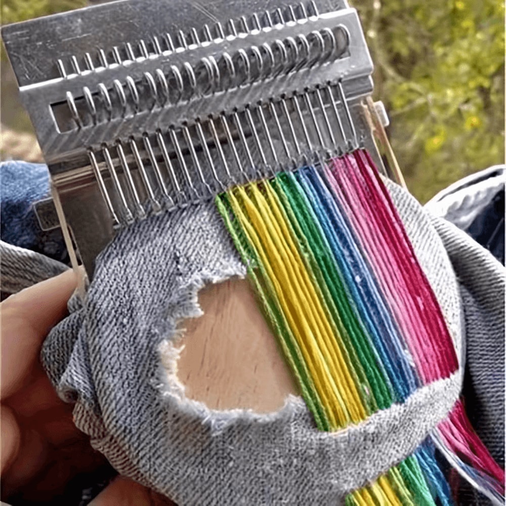 hands fixing sock with darning loom