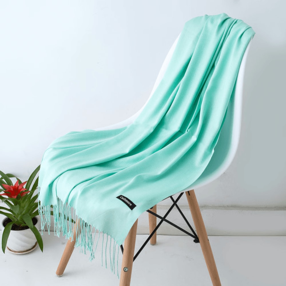 Cozy cashmere scarf folded on table