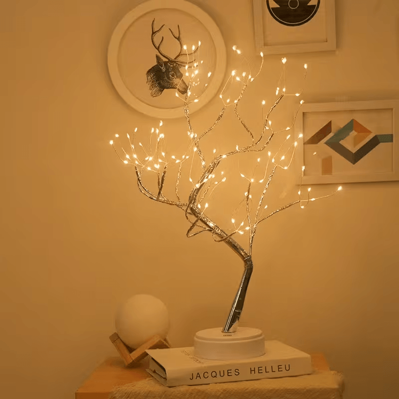 Fairy Light Tree Lamp glowing next to a comfortable armchair