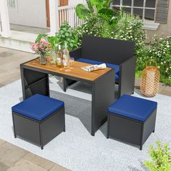 4-piece outdoor dining set with wood-topped table, rattan loveseat chair & 2 ottomans