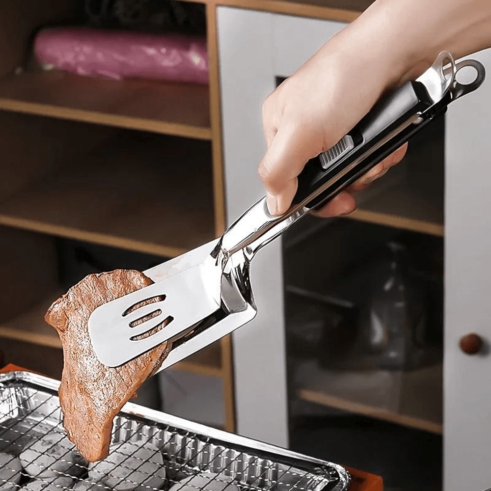 spatula tongs holding food steady while turning