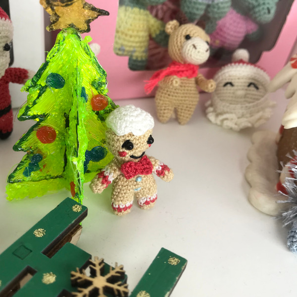 Gingerbread man near the Christmas tree with friends