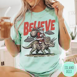 funny christmas comfort colors t-shirt believe in santa shirt, unisex santa dinosaur ufo tee