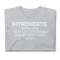 Introverts Unite We're Here We're Uncomfortable And We Want To Go Home." Perfect for introverted men, women, and kids who dislike social event situations.Short-Sleeve Unisex T-Shirt