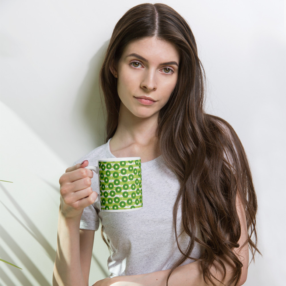 Kiwi slices on a striped background coffee mug