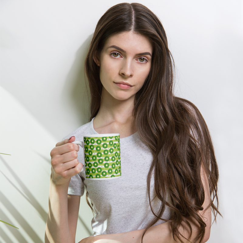 Kiwi slices on a striped background coffee mug